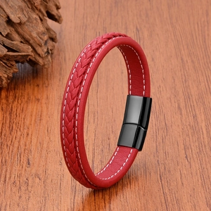 Close-up of red braided leather bracelet with black magnetic clasp and white stitching