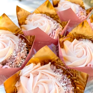 Pink and gold metallic tulip cupcake liners with elegant rose frosting and sugar pearls