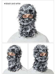 Detail showing high-density black and white knit texture and long fringe on the balaclava