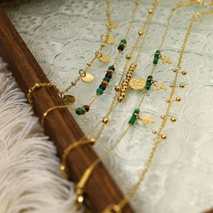 Bracciale retrò fatto a mano con perle di malachite, catena d'oro e ciondoli a disco
