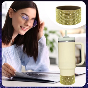 Detail of champagne gold rhinestone silicone boot on insulated tumbler base for protection
