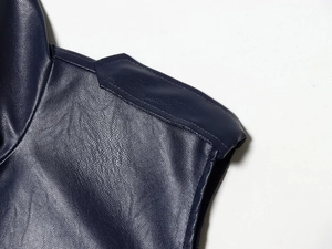 Close-up of high-quality faux leather texture and reinforced stitching on blue skirt