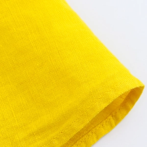 Macro view of yellow linen fabric texture showing detailed cross-weave and stitching