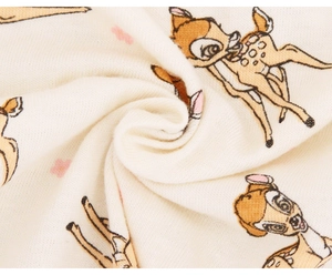 Close-up of soft knitted fabric with deer print and fine texture for baby crib sheet
