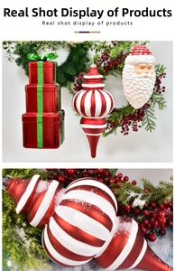 Close-up of red and white striped Christmas onion drop ornament and festive gift boxes