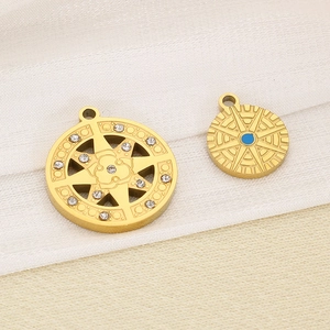 Detailed view of stainless steel North Star pendants with rhinestones and blue enamel