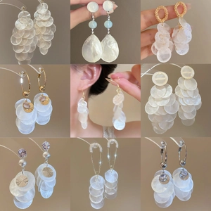 Elegant collection of nine circular shell tassel earrings with silver needles for beach style