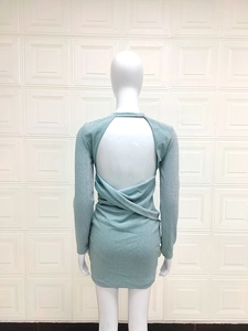 Detail of light blue glitter bodycon dress showing backless twist knot and long sleeves