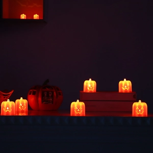 Set of Halloween pumpkin LED lanterns with spooky faces emitting warm orange light