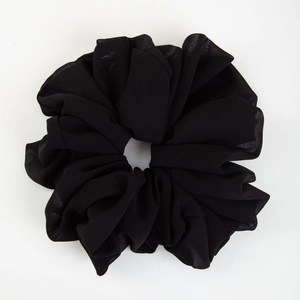 Detail of high-elasticity black chiffon scrunchie showing its soft texture and pleats
