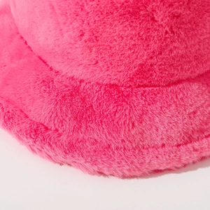 Close-up of fluffy rose pink plush bucket hat showing faux fur texture and stitching detail