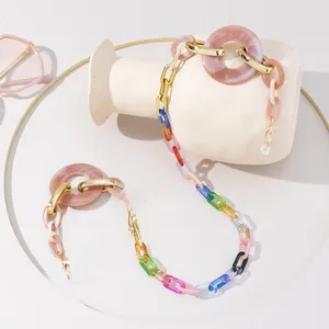 Dettaglio della catena per occhiali in acrilico colorato con anelli rosa e chiusura oro