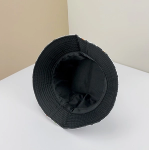 Detail of internal black cotton lining and durable stitching on reversible bucket hat
