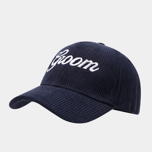 Dark blue corduroy baseball cap with white Groom embroidery in 45-degree angle view