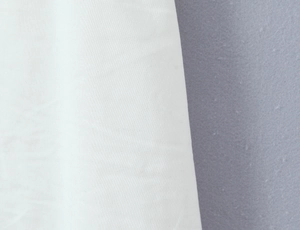 Detailed macro view showing white and blue-grey sailor dress fabric texture and quality