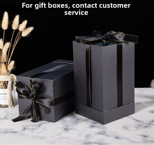 Detail of luxury dark grey rectangular gift box with gold-edged black ribbon and bow