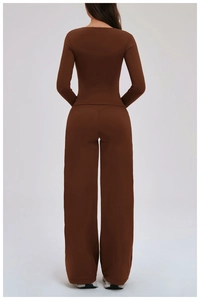 Detail view of the back of a deep brown yoga set featuring a long sleeve top and wide-leg pants