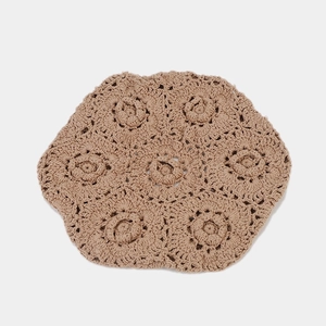 Close-up of khaki hollow crochet pattern cotton knit fabric with floral design details