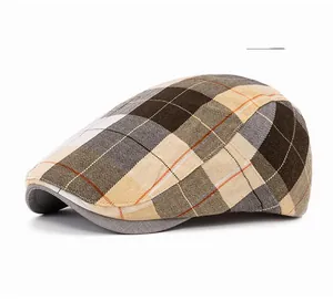 Detailed side view of a beige plaid ivy cap with visible twill texture and stitching