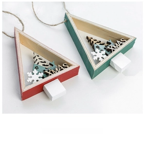 Detail of red and green wooden Christmas tree ornaments with festive Xmas engravings