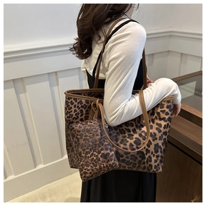 Detail of leopard print tote bag set featuring large shoulder bag and matching small pouch