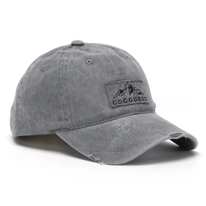 Close-up of distressed gray washed cotton baseball cap with mountain patch embroidery