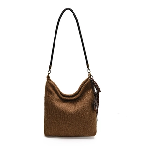 Brown fuzzy wool shoulder bag with black strap and leather tassel charm for autumn