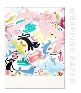 Close-up of stacked gift boxes wrapped in colorful cartoon animal pattern paper with a bow