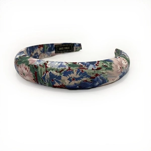 Detail of bohemian floral print padded headband with retro oil painting style and handmade label