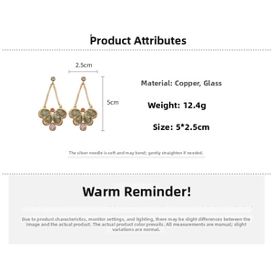 Detail view showing vintage crystal butterfly earrings with precise size and weight data
