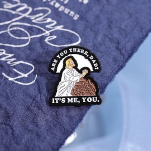 Funny Jesus enamel pin with humorous prayer text on a dark textured background