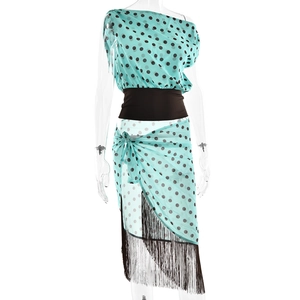 Detail of teal polka dot two-piece set with black fringe hem and waist belt