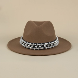 Detail of elegant pearl beading on black satin ribbon of a camel wool fedora hat