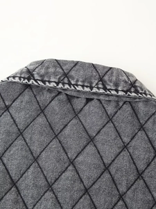 Detail of grey washed denim collar with diamond quilted pattern and vintage texture