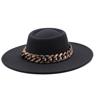Detailed view of black wool fedora featuring a bold decorative gold chain accent