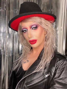Fashionable red and black wool felt jazz hat with a black leather biker jacket