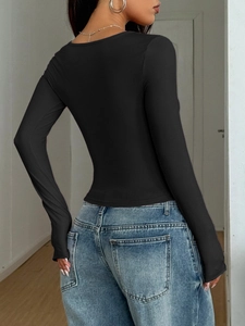 Rear view of a slim fit black long sleeve Y2K top worn with blue jeans indoors