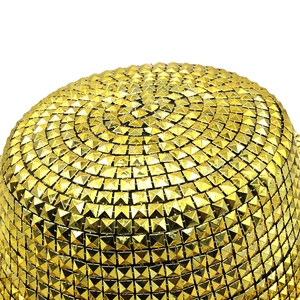 Close-up of golden jazz hat top featuring all-over square pyramid metallic rivets