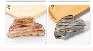 Detail of heart hair claws with marble texture and sparkling rhinestone edges