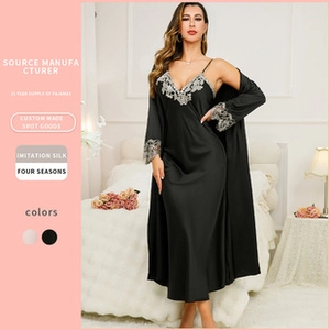 Detail of black silk nightgown with delicate white lace trim and matching robe set