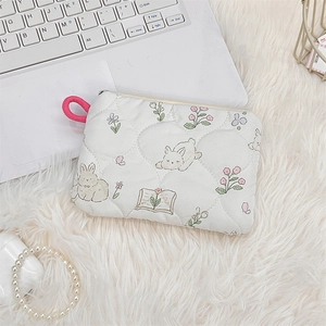 Close-up of quilted cotton cosmetic bag with cute rabbit print and pink zipper handle