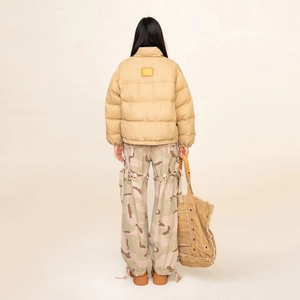 Rear view of khaki explorer mountain parka with stand collar and loose fit silhouette