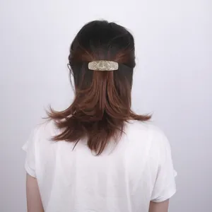 Vintage metal hair clip with Tree of Life engraving and Celtic knot patterns on a woman