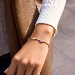 18K gold plated stainless steel tennis bracelet with pink heart zircon on female wrist