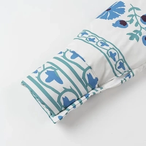 Detailed macro view of sleeve cuffs with blue floral prints and reinforced stitching