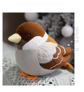 Detailed view of sparrow plush toy with soft texture on a cozy white woven blanket