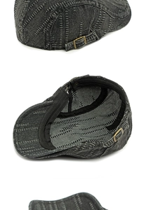 Detail of adjustable brass buckle and vertical striped stitching on a denim ivy cap