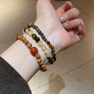 Stacked beaded bracelets with natural yellow rutilated quartz and brown tiger eye stones