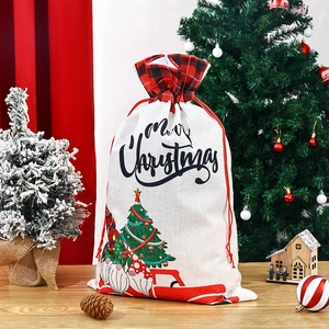 Close-up of Merry Christmas drawstring gift bag with festive forest gnome and truck prints