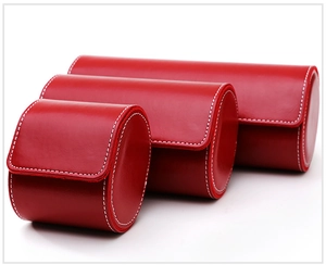 Three red leather watch storage boxes in different sizes with white stitching details